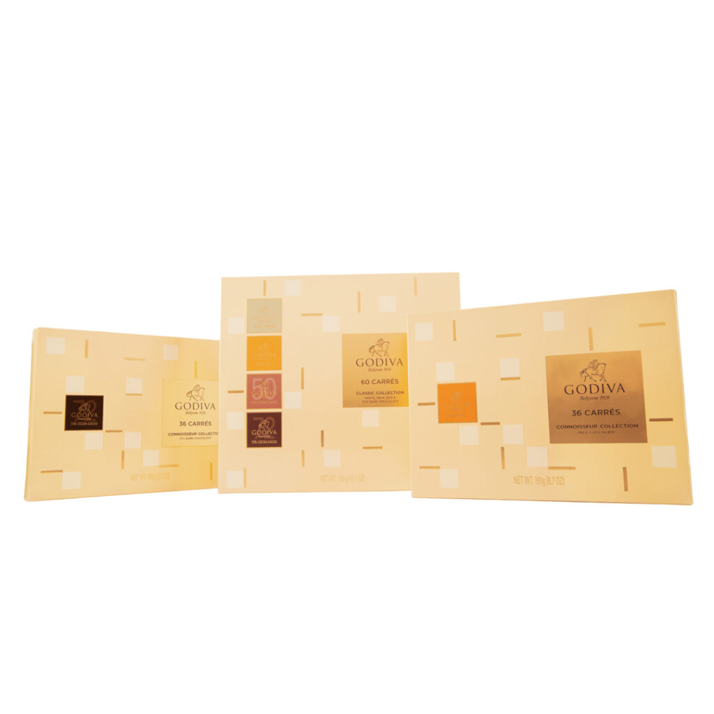 Set of three beige Godiva chocolate boxes with assorted Carres – group product shot for e-commerce by Food On Focus Media
