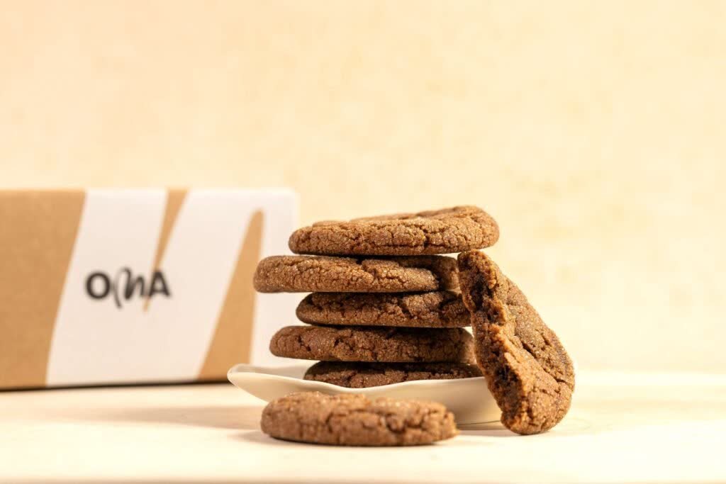 Stack of OMA cookies beside branded packaging, from our monthly OMA Bakery content