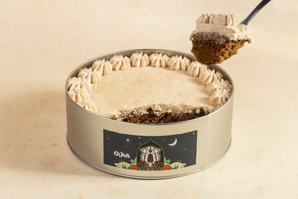 A branded Ramadan dessert tin with a serving lifted out on a spoon