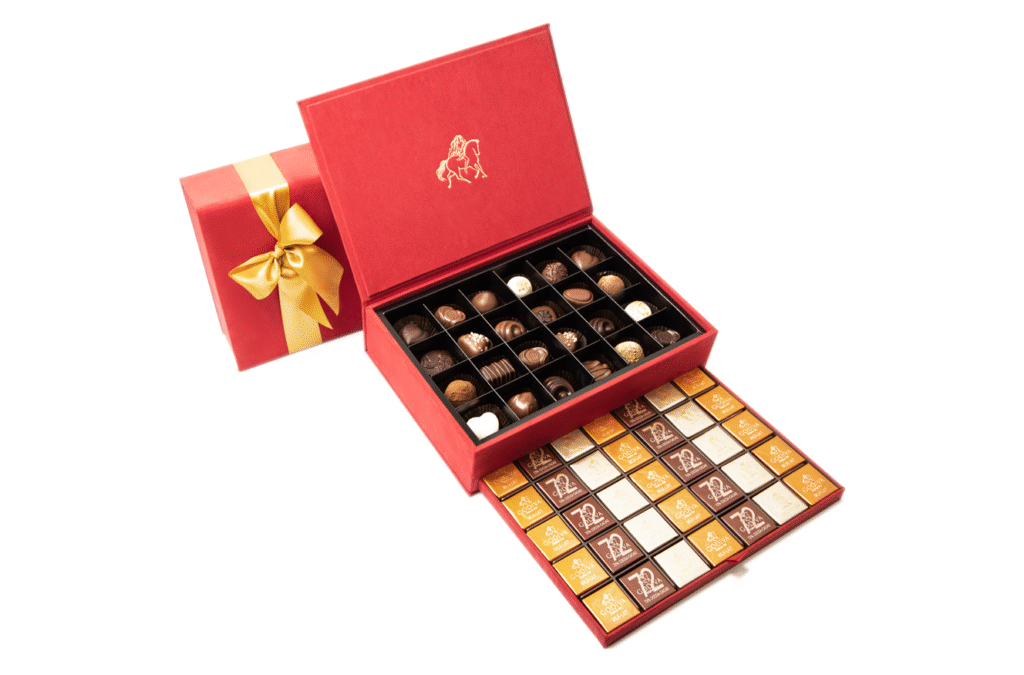 Elegant red Godiva chocolate box with gold ribbon, filled with assorted gourmet chocolates – e-commerce product photography by Food On Focus Media
