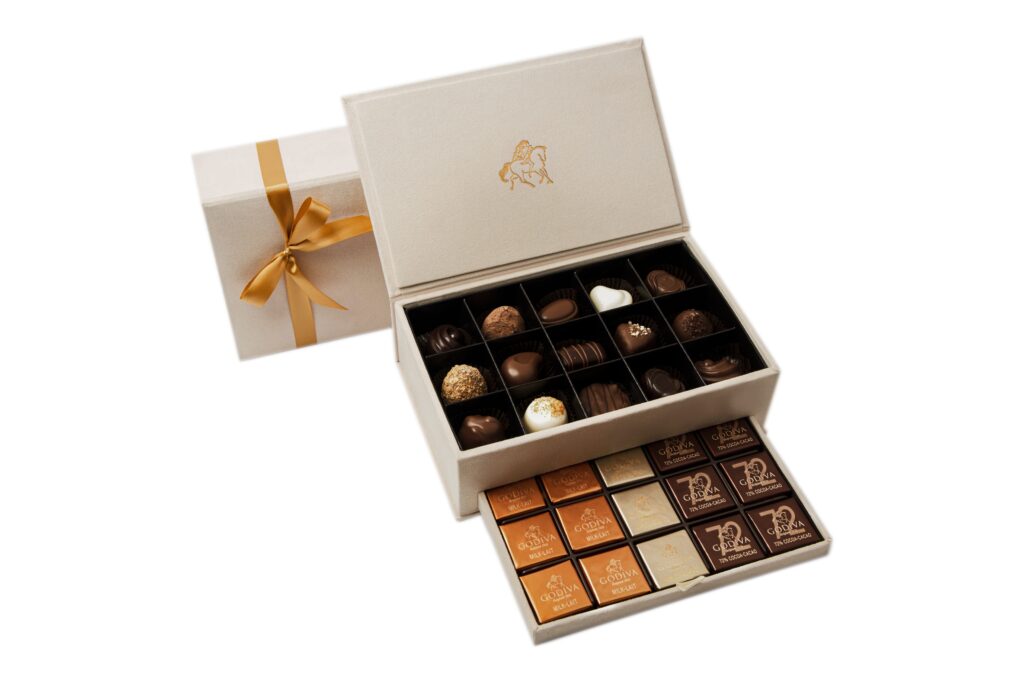Godiva open white box with golden ribbon and assorted premium chocolates – luxury gift packaging product image