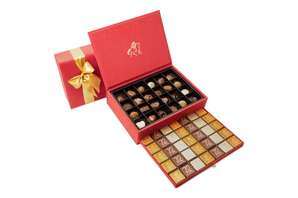 Red Godiva chocolate box with gold ribbon and assorted chocolates – product photo for luxury gifting e-commerce