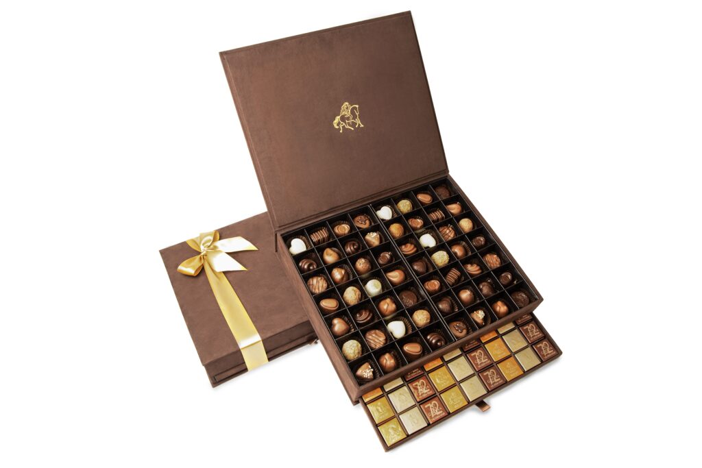 Open brown Godiva chocolate gift box with assorted truffles and pralines – luxury e-commerce product photo UAE