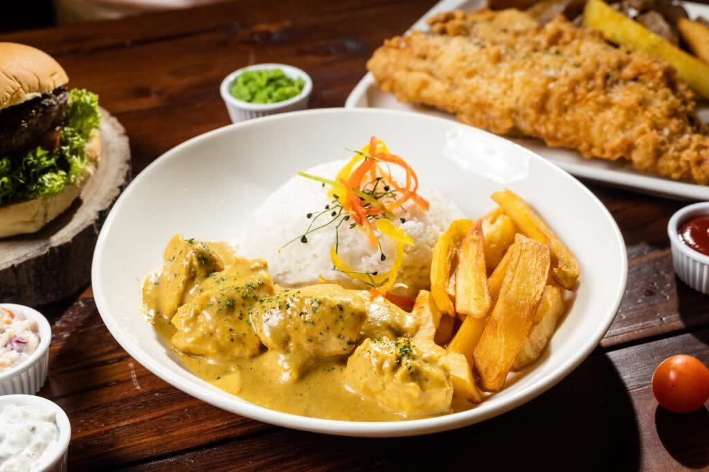 Curry served with rice on a pub table, surrounded by other menu dishes, from our Irish Vickers menu shoot