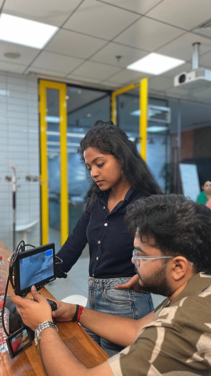 Two people at a desk reviewing campaign content on a monitor