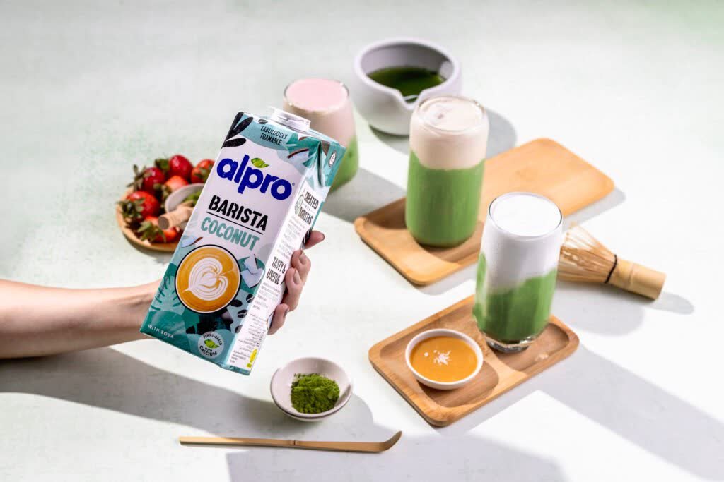 Alpro Barista carton styled with a berry bowl and matcha on a wooden tray