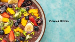 Colorful smoothie bowl with fruit, nuts, and seeds photographed from above