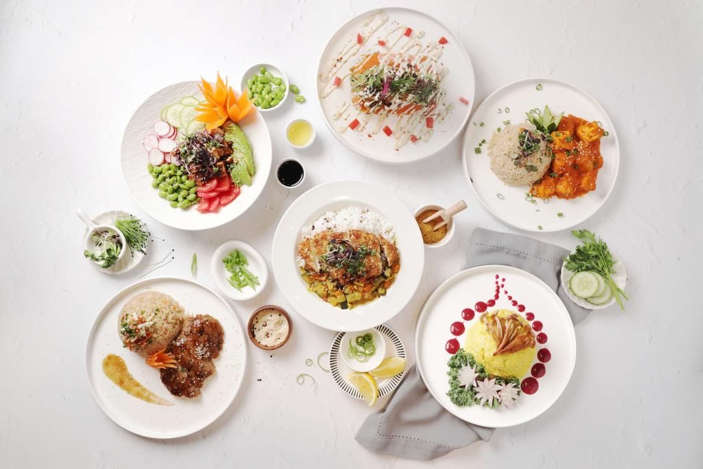 Six menu dishes shot overhead in white crockery, every plate fully inside the frame